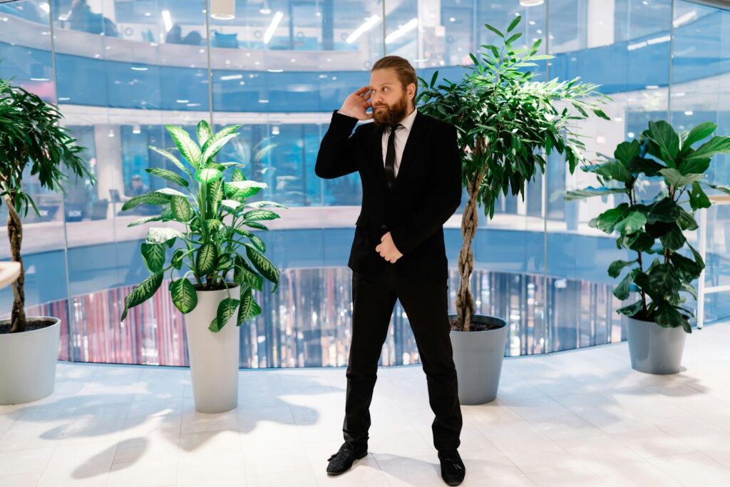 Confident security guard standing in business center