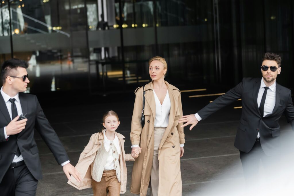 private security, personal bodyguards protecting female clients, blonde woman and daughter walking